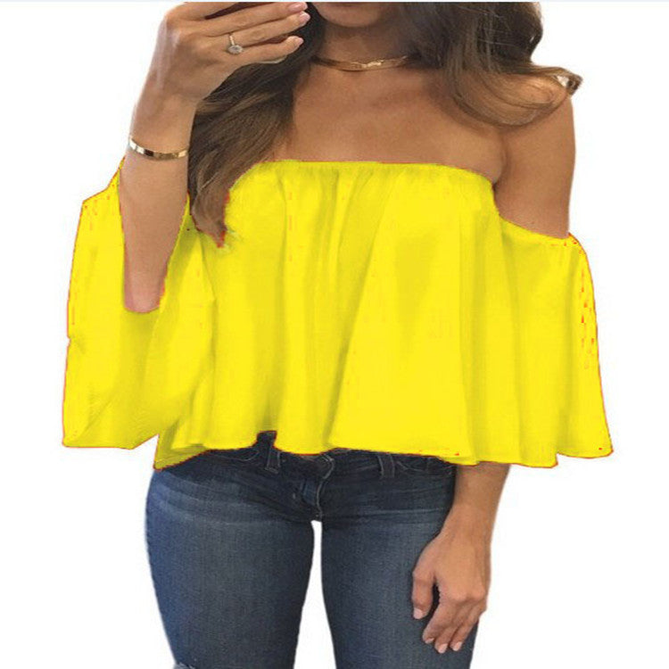 Yellow off-shoulder top worn by a person on a white background
