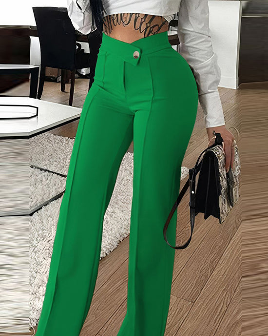Person wearing green pants and a white top in an indoor setting