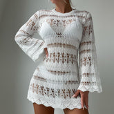 White lace dress with long sleeves on a plain background