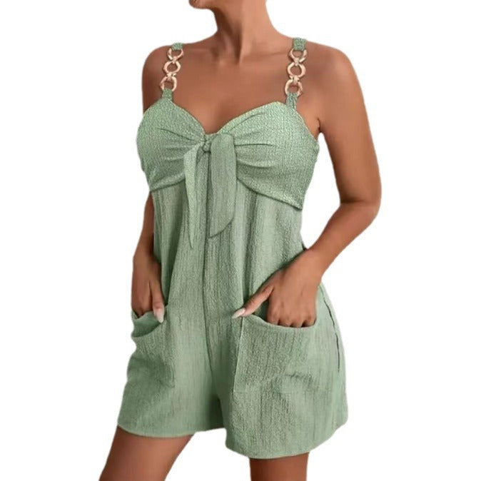 Green romper with a tie detail on a white background