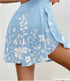 Light blue skirt with white floral pattern on a plain background