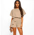 Woman wearing a beige romper on a white background