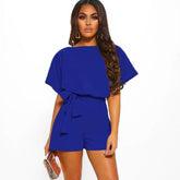 Woman wearing a blue romper on a white background