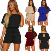 Woman modeling a black romper with different color options displayed.