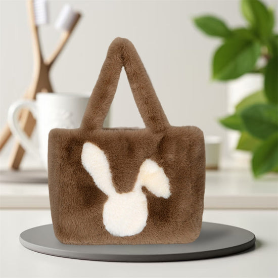 A cute, large, plush, bunny-shaped travel bag for women with ears and a fluffy tail