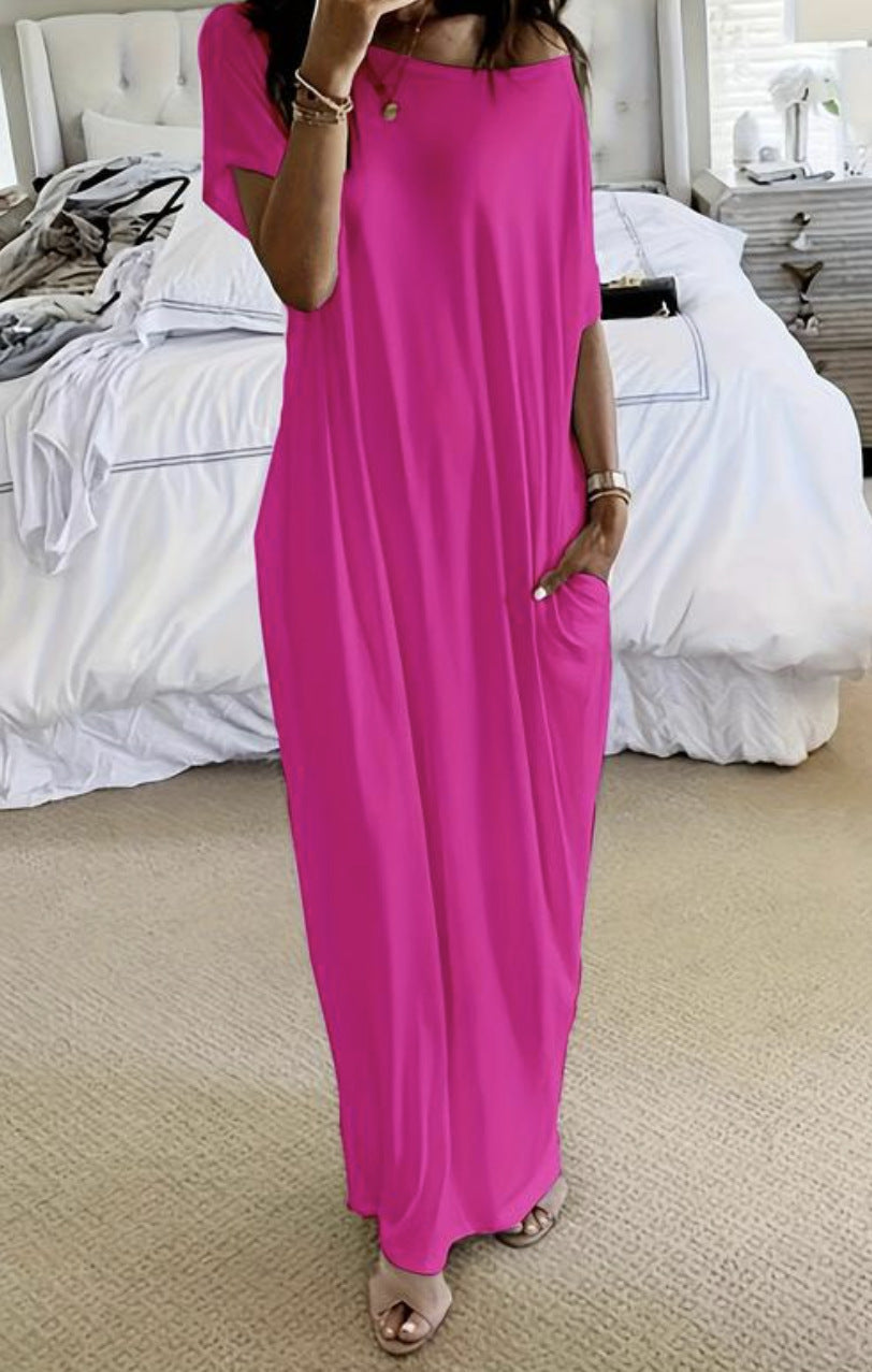 Person wearing a bright pink dress in a bedroom setting