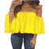 Yellow off-shoulder top worn by a person on a white background