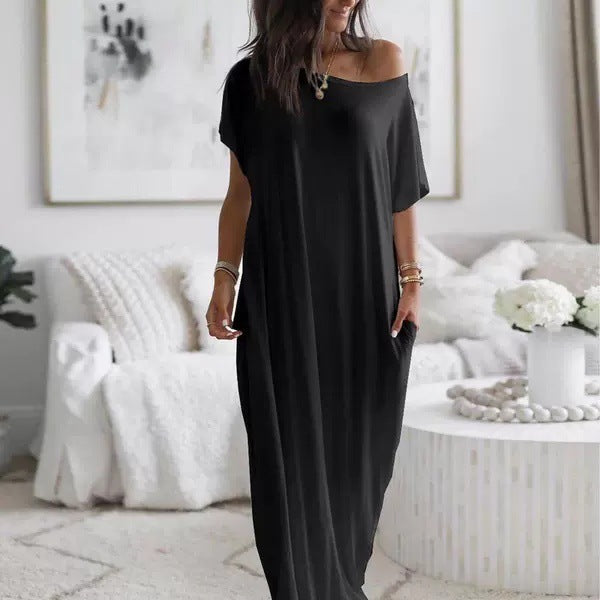Woman wearing a black off-shoulder dress in a living room setting