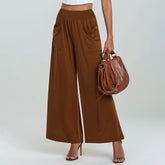 Brown wide-leg pants with a matching handbag on a plain background