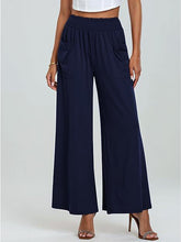 Navy wide-leg pants worn by a person on a white background
