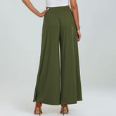 Person wearing olive green wide-leg pants on a white background