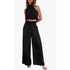 Black two-piece outfit with a halter top and wide-leg pants on a white background