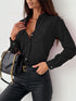 Woman wearing a black shirt and pants with a black handbag against a white background