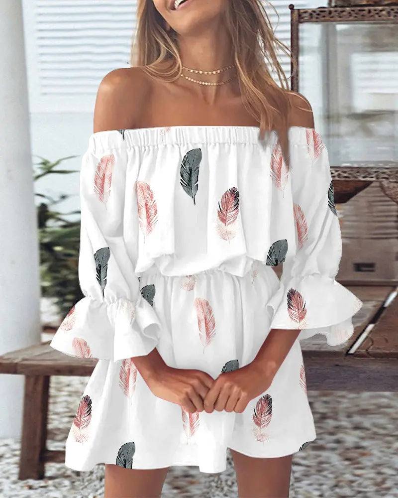 Woman wearing a white off-shoulder dress with feather pattern in an outdoor setting