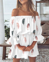 Woman wearing a white off-shoulder dress with feather pattern in an outdoor setting