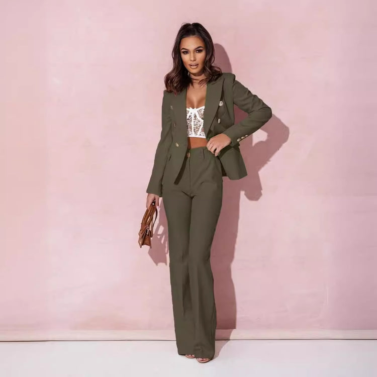 Woman wearing a green suit with a white top against a pink background