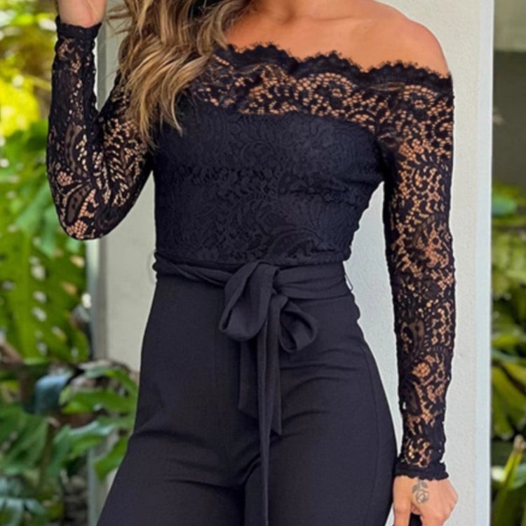 Black lace long-sleeve top and pants worn by a person with greenery in the background