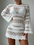 White lace dress with long sleeves on a plain background