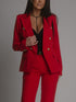Red suit with gold buttons worn by a person on a gray background