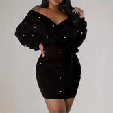 Black off-shoulder dress with pearl embellishments on a plain background