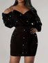 Black dress with pearl embellishments on a plain background