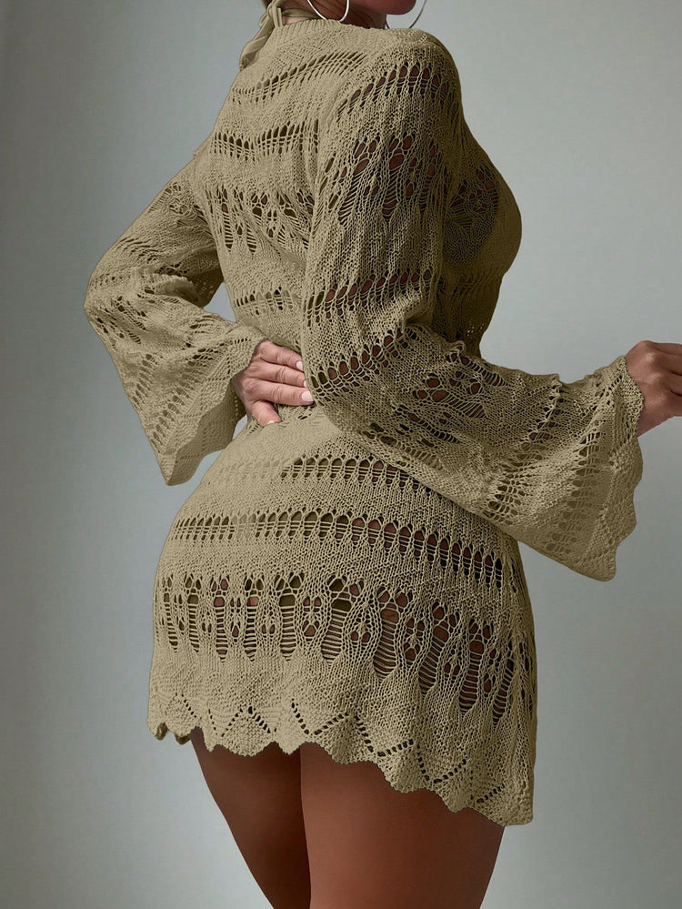 Beige knitted dress with intricate patterns on a plain background