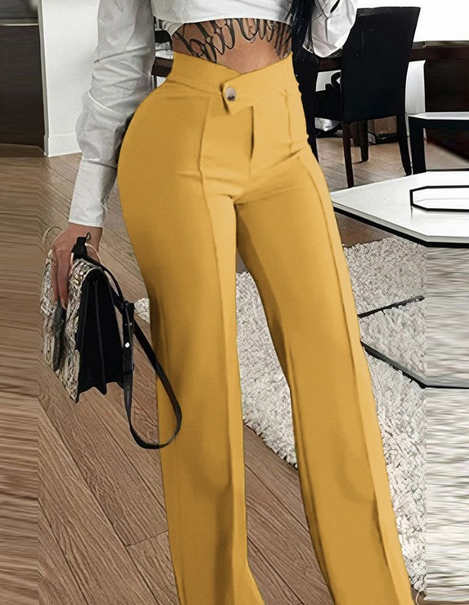 Person wearing mustard yellow pants with a blurred indoor background